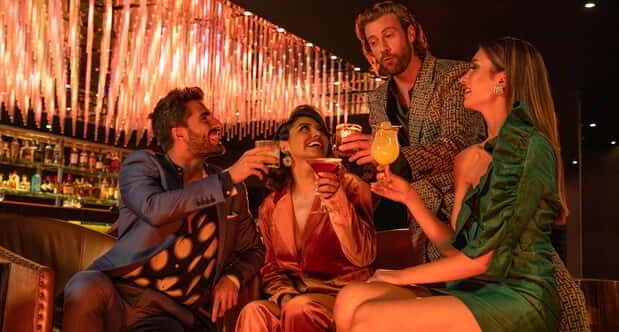 Group of two men and two women drinking at Aurora.